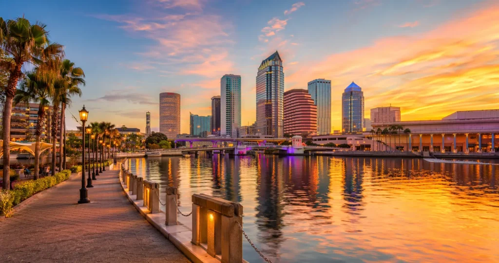 Tampa Riverwalk at sunset with skyline reflections
