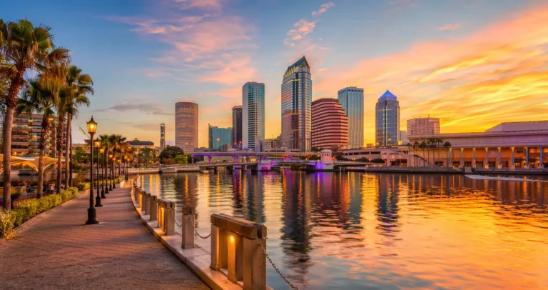 Tampa Riverwalk at sunset with skyline reflections