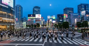 Shibuya Crossing at dusk with pedestrians crossing in organized flow, Tokyo