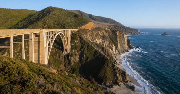 Bixby Creek Bridge on the Big Sur coast along California Highway 1 during clear morning light.