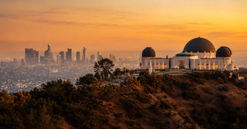 Griffith Observatory overlooking Los Angeles skyline at sunset