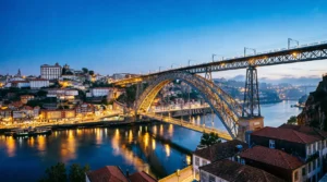The Dom Luís I Bridge connecting Porto and Vila Nova de Gaia at sunset.