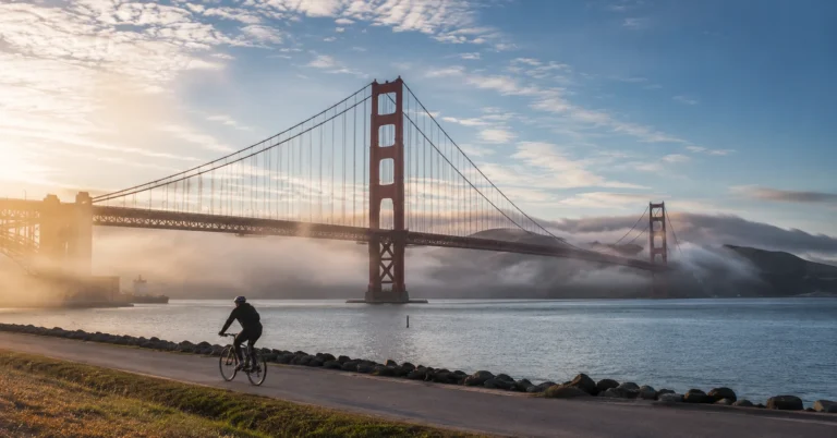 Golden Gate Bridge at sunrise from Crissy Field with morning fog lifting, San Francisco