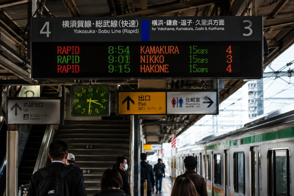 JR train platform in Tokyo showing departure times for day trip destinations
