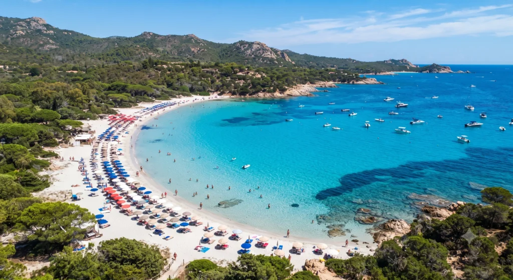 Aerial view of a turquoise cove with white sand and clear water on a top beach in France.