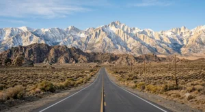 A long stretch of California Highway 395 stretching toward the dramatic granite peaks of the Eastern Sierra.