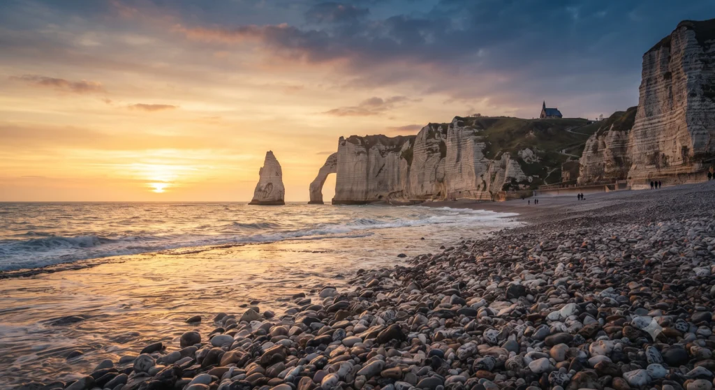 White chalk cliffs and a pebble beach at Étretat on the Normandy coast.