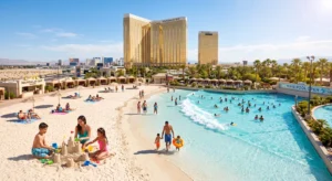 Wide shot of the Mandalay Bay wave pool and sandy beach area under bright sunlight with families swimming
